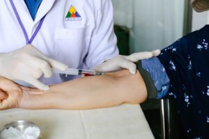 taking blood from patients arm